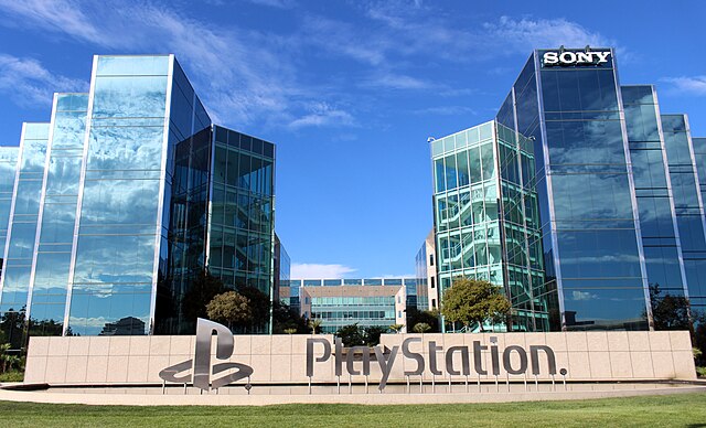 PlayStation logo with a backdrop of office environment