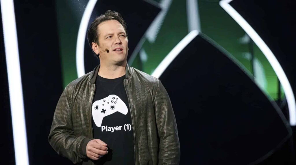 Phil Spencer speaking at an Xbox event, reassuring players about their game libraries and Game Pass.