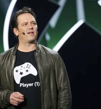 Phil Spencer speaking at an Xbox event, reassuring players about their game libraries and Game Pass.