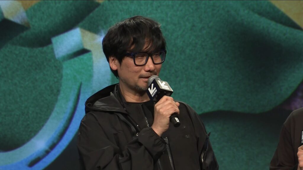 Hideo Kojima on stage at SXSW 2025 revealing the new Death Stranding 2 trailer.