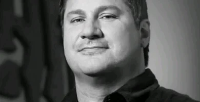 Portrait of Bill Petras, Blizzard art director, with Overwatch and World of Warcraft artwork in the background