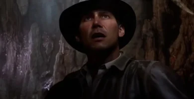 Frustrated gamers holding Indiana Jones and the Great Circle PS5 disc with error screen in background