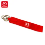 Red Nintendo Switch 2 wristlet keychain with logo, available through My Nintendo reward program