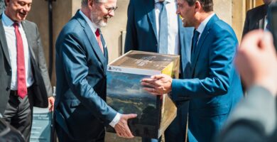 Czech Prime Minister Petr Fiala smiling while receiving Kingdom Come: Deliverance 2 Collector’s Edition from Mayor Lukáš Seifert