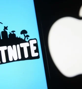 Tim Sweeney speaking at a tech event with Fortnite and Apple logos in the background.