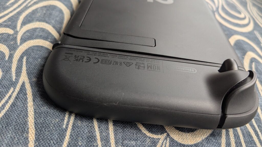 Close-up of Nintendo Switch 2 with back panel lifted due to swelling