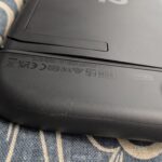 Close-up of Nintendo Switch 2 with back panel lifted due to swelling