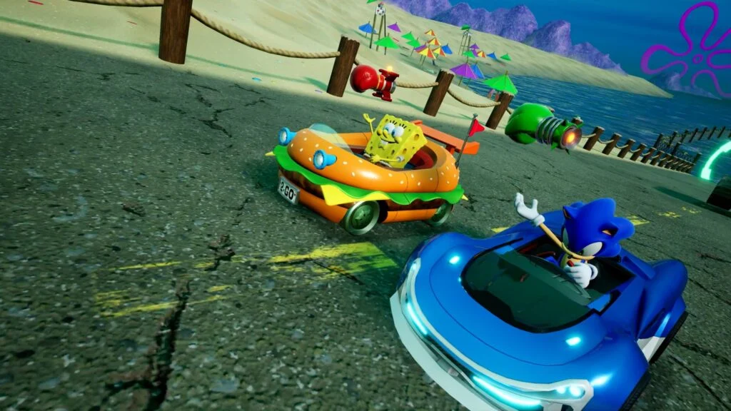 SpongeBob and Patrick race in Sonic Racing: CrossWorlds with Krabby Patty-themed cars on a Bikini Bottom track.