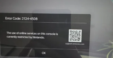 Nintendo Switch 2 console with red warning sign overlay indicating ban risk from secondhand purchases