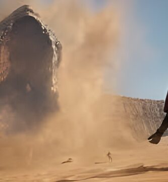 Dune Awakening gameplay showing desert combat and sandworm encounter