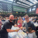 Simon Cowell shakes hands with a Pokémon card vendor at the London Cards & Collectibles Convention