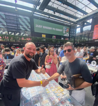 Simon Cowell shakes hands with a Pokémon card vendor at the London Cards & Collectibles Convention