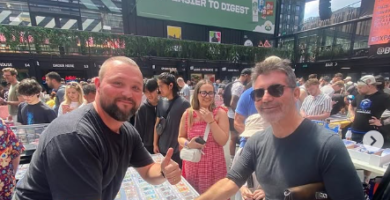 Simon Cowell shakes hands with a Pokémon card vendor at the London Cards & Collectibles Convention