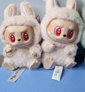 Side-by-side comparison of real and fake Labubu plush toys with visible tags and QR codes